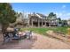 Inviting backyard with a fire pit and patio area, set against the backdrop of a well-maintained lawn at 4 White Fir Ct, Littleton, CO 80127