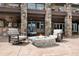 Back patio features stone fire pit and cozy seating area at 4 White Fir Ct, Littleton, CO 80127