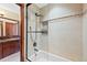 Bright bathroom with a tiled shower, glass door, and view into vanity area at 4 White Fir Ct, Littleton, CO 80127