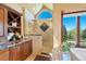 Bright bathroom with a glass-enclosed shower, vanity with granite countertops, and large window with outdoor views at 4 White Fir Ct, Littleton, CO 80127