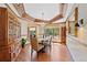 Elegant dining room featuring a coffered ceiling, hardwood floors, a bay window, and a stylish chandelier at 4 White Fir Ct, Littleton, CO 80127