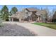 A view of a charming two-story home featuring a well-maintained front yard, a concrete driveway, and an attached garage at 4 White Fir Ct, Littleton, CO 80127