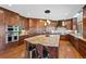 Spacious kitchen features a large island with stone countertops, wooden cabinets, and stainless steel appliances at 4 White Fir Ct, Littleton, CO 80127