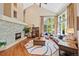 Bright living room boasting a high ceiling, fireplace, hardwood floors, and lots of natural light from large windows at 4 White Fir Ct, Littleton, CO 80127