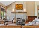 Comfortable living room featuring a stone fireplace, hardwood floors, and accent lighting at 4 White Fir Ct, Littleton, CO 80127