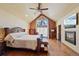 Vaulted main bedroom features a fireplace, hardwood floors, and a large window with lots of natural light at 4 White Fir Ct, Littleton, CO 80127