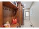 Functional mudroom with wooden built-ins, hooks, and a bench, offering practical storage solutions at 4 White Fir Ct, Littleton, CO 80127