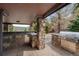 Outdoor kitchen features stainless steel grill, stone countertops, and ample storage at 4 White Fir Ct, Littleton, CO 80127