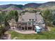Expansive home exterior boasting a patio, built-in hot tub, and picturesque mountain views at 4 White Fir Ct, Littleton, CO 80127