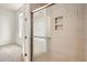 Modern shower with sliding glass door and built-in shower caddy at 336 E 1St Ave # 200, Denver, CO 80203