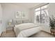 Bright bedroom featuring a large window and simple yet elegant decor at 336 E 1St Ave # 200, Denver, CO 80203