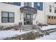 Entrance of the building with snow-covered steps and a glass door at 336 E 1St Ave # 200, Denver, CO 80203