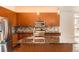 Close-up of kitchen showcasing granite countertops, stainless steel appliances, and an island with a sink at 336 E 1St Ave # 200, Denver, CO 80203