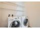 Functional laundry room with white washer and dryer, plus wire shelving for convenient storage at 336 E 1St Ave # 200, Denver, CO 80203