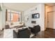 Cozy living room with contemporary decor, a modern fireplace, mounted TV, and ample natural light at 336 E 1St Ave # 200, Denver, CO 80203