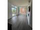 Bright living room featuring hardwood floors, large windows, and sliding door to balcony at 336 E 1St Ave # 200, Denver, CO 80203