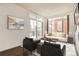 Bright living room with large windows, modern furniture, and dark hardwood floors at 336 E 1St Ave # 200, Denver, CO 80203
