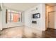 Living room with a fireplace, mounted TV, and large window at 336 E 1St Ave # 200, Denver, CO 80203