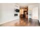 Living room with a fireplace, mounted TV, and view of the kitchen at 336 E 1St Ave # 200, Denver, CO 80203