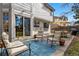 Cozy back patio with furniture, an umbrella, and a blue outdoor rug to add a pop of color at 8427 Pierson Ct, Arvada, CO 80005