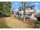 Spacious backyard with patio, outdoor dining set, lush lawn, and mature trees at 8427 Pierson Ct, Arvada, CO 80005