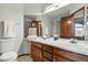 Bathroom featuring double vanity with wooden cabinets and countertop space at 8427 Pierson Ct, Arvada, CO 80005