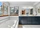 Bright bathroom features a soaking tub, a double sink vanity, and large window at 8427 Pierson Ct, Arvada, CO 80005