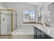 Bright bathroom features a soaking tub, glass shower, and a modern vanity at 8427 Pierson Ct, Arvada, CO 80005