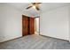 Spacious bedroom with a wooden door and a ceiling fan at 8427 Pierson Ct, Arvada, CO 80005