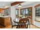 Cozy dining area features sliding glass doors to the yard and backyard views at 8427 Pierson Ct, Arvada, CO 80005