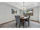 Cozy dining room with a round table, upholstered chairs, and natural light from the window at 8427 Pierson Ct, Arvada, CO 80005