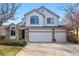 Charming two-story home featuring a brick facade, white siding, and a three-car garage at 8427 Pierson Ct, Arvada, CO 80005