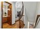 Hallway features wood floors and an elegant wood railing staircase leading to the main level and basement at 8427 Pierson Ct, Arvada, CO 80005