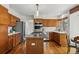 Bright eat-in kitchen features wood floors, central island with cooktop, and stainless steel appliances at 8427 Pierson Ct, Arvada, CO 80005