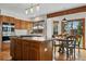 Bright eat-in kitchen features wood floors, central island with cooktop, and stainless steel appliances at 8427 Pierson Ct, Arvada, CO 80005