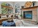 Comfortable living room features a brick fireplace, arched windows, and stylish decor at 8427 Pierson Ct, Arvada, CO 80005