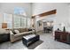 Bright living room featuring large windows, a comfortable sofa, and an adjacent dining area at 8427 Pierson Ct, Arvada, CO 80005