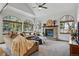 Bright living room featuring large windows, a brick fireplace, and comfortable sofas at 8427 Pierson Ct, Arvada, CO 80005