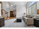 Spacious living room with high ceilings, large windows, comfortable seating, and staircase in view at 8427 Pierson Ct, Arvada, CO 80005