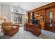 Comfortable office features custom wood shelves, a large window, and plush armchair at 8427 Pierson Ct, Arvada, CO 80005