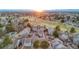 Gorgeous aerial view shows the property nestled in lush landscape with a golf course and mountain views at 2061 S Worchester Way, Aurora, CO 80014