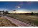 Picturesque sunset view of the backyard and adjacent golf course creating a peaceful scene at 2061 S Worchester Way, Aurora, CO 80014