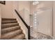 Welcoming foyer with coat closet, tiled floor detail and staircase leading to the main living area at 2061 S Worchester Way, Aurora, CO 80014