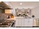 Bright, updated kitchen features white cabinets, stainless steel appliances, and sleek countertops at 2061 S Worchester Way, Aurora, CO 80014