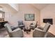 Cozy living room features four chairs surrounding a glass coffee table, fireplace and modern art at 2061 S Worchester Way, Aurora, CO 80014