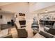 Open floor plan view of the living room with fireplace, wet bar and kitchen bar with seating at 2061 S Worchester Way, Aurora, CO 80014