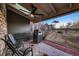 Cozy covered patio featuring a grill, seating, and scenic backyard view at 2061 S Worchester Way, Aurora, CO 80014