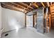 Unfinished basement area with painted floors, exposed ceiling, and mechanicals at 1475 S Eaton St, Lakewood, CO 80232