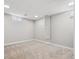 Finished basement offers neutral carpet, paneled walls, recessed lighting, and small windows at 1475 S Eaton St, Lakewood, CO 80232