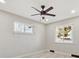 Bright bedroom features modern ceiling fan, neutral walls, two windows, and light, wood-look flooring at 1475 S Eaton St, Lakewood, CO 80232
